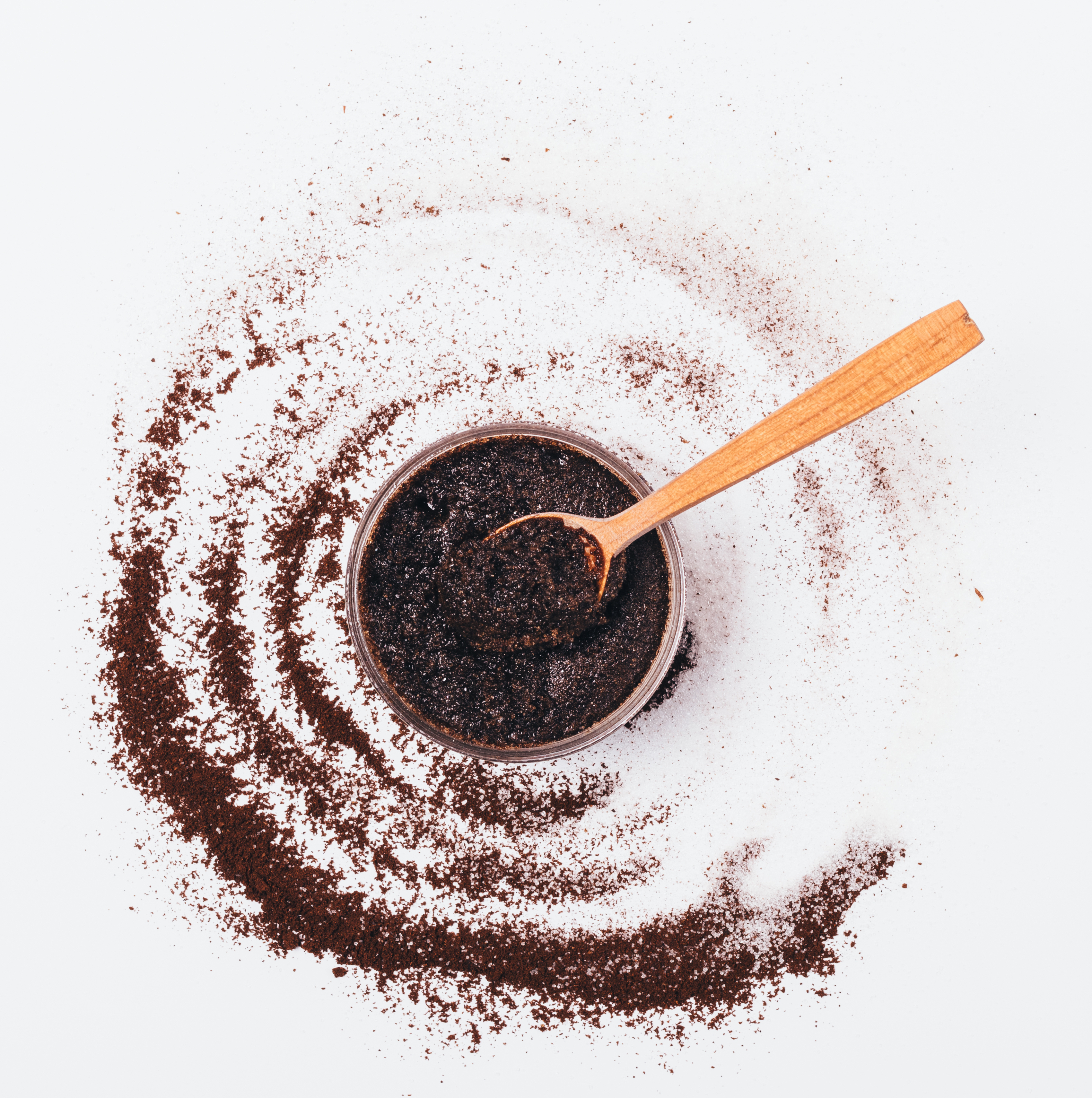The picture shows a cup with spoon and coffee grounds