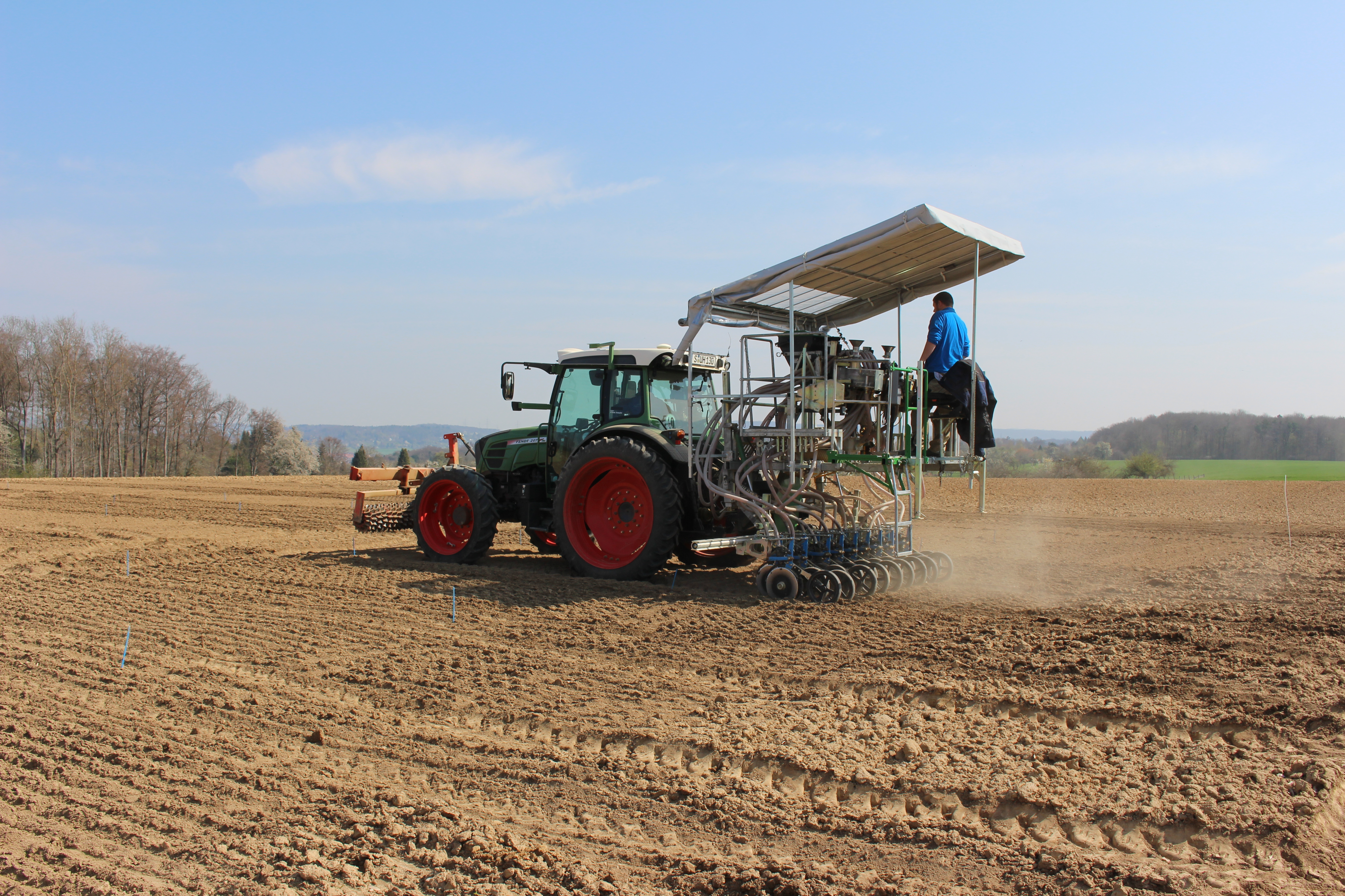 The photo shows a seeder on a field.