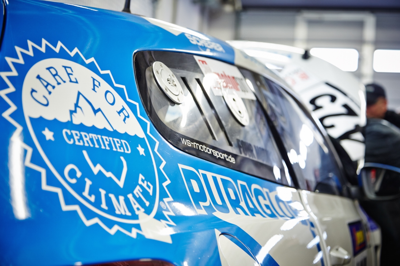Photo of the blue-white mud wing of a Bioconcept car with the text 